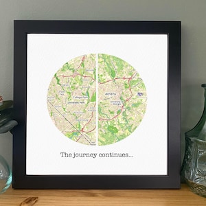 May include: A black framed print with a map of Athens, Georgia and College Park, Georgia. The map is divided in half and the text "The journey continues..." is printed below the map.