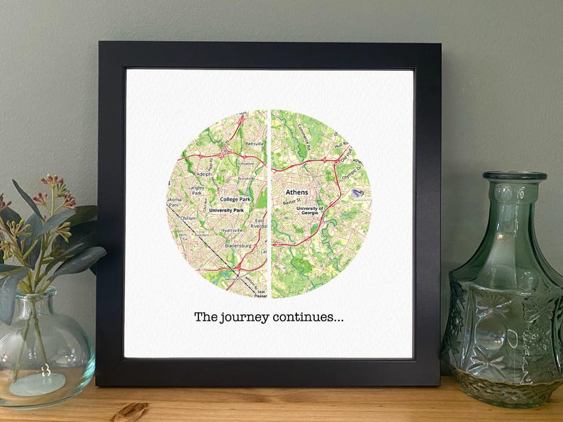 May include: A black framed print with a map of Athens, Georgia and College Park, Georgia. The map is divided in half and the text "The journey continues..." is printed below the map.
