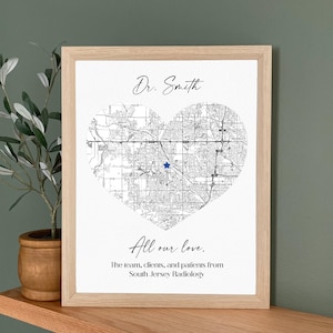 May include: Framed print featuring a heart-shaped map with a blue star marking a location. The text "Dr. Smith" is above the map, and "All our love" is below, with a dedication from South Jersey Radiology.