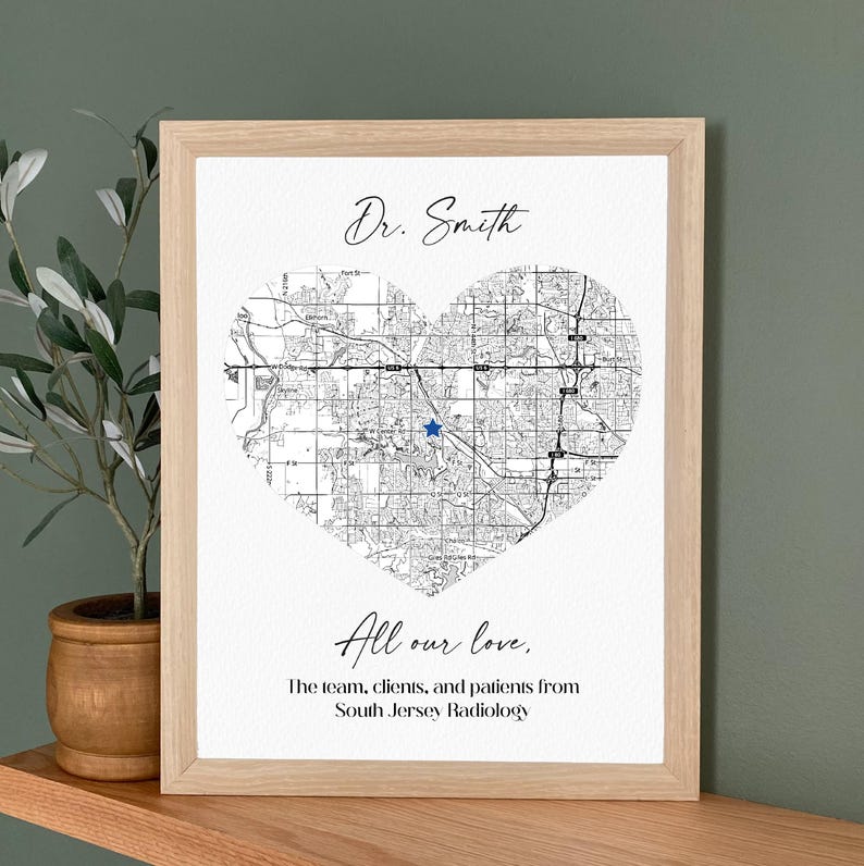 May include: Framed print featuring a heart-shaped map with a blue star marking a location. The text "Dr. Smith" is above the map, and "All our love" is below, with a dedication from South Jersey Radiology.