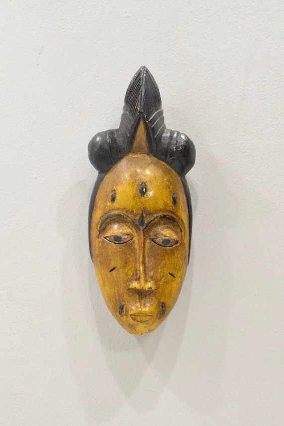 Sold at auction Three African Carved Wood Passport Masks