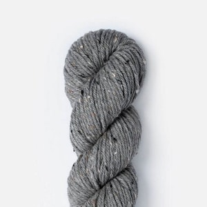 May include: A skein of gray yarn with flecks of white and black. The yarn is twisted into a rope shape.