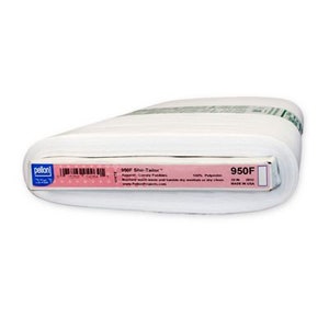 May include: A roll of white fabric labeled "950F Shir-Tailor" with a pink and white label. The label includes the brand name "Pellon" and a barcode. The fabric is 20 inches wide and made of 100% polyester.