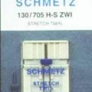 May include: A package of 4 Schmetz 130/705 H-S ZWI stretch sewing machine needles. The package is white with blue lettering and the needles are in a clear plastic case.