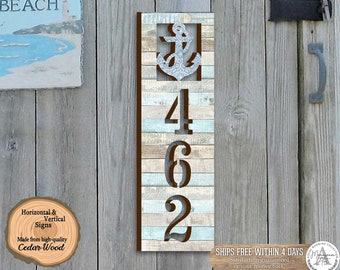 May include: A vertical wooden sign with a distressed blue and white paint finish. The sign features a large anchor with a silver finish and the numbers 462 cut out of the wood. The sign is made from cedar wood and is perfect for a nautical themed home.