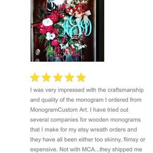 May include: Five star review of a custom monogram made by Monogram Custom Art. The monogram is turquoise blue and is displayed on a wreath with red and white flowers. The reviewer states that they were very impressed with the craftsmanship and quality of the monogram.
