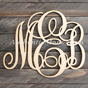 May include: A wooden monogram with the letters M, B, and J in a cursive script. The letters are cut out of a single piece of wood and are arranged in a circular pattern.