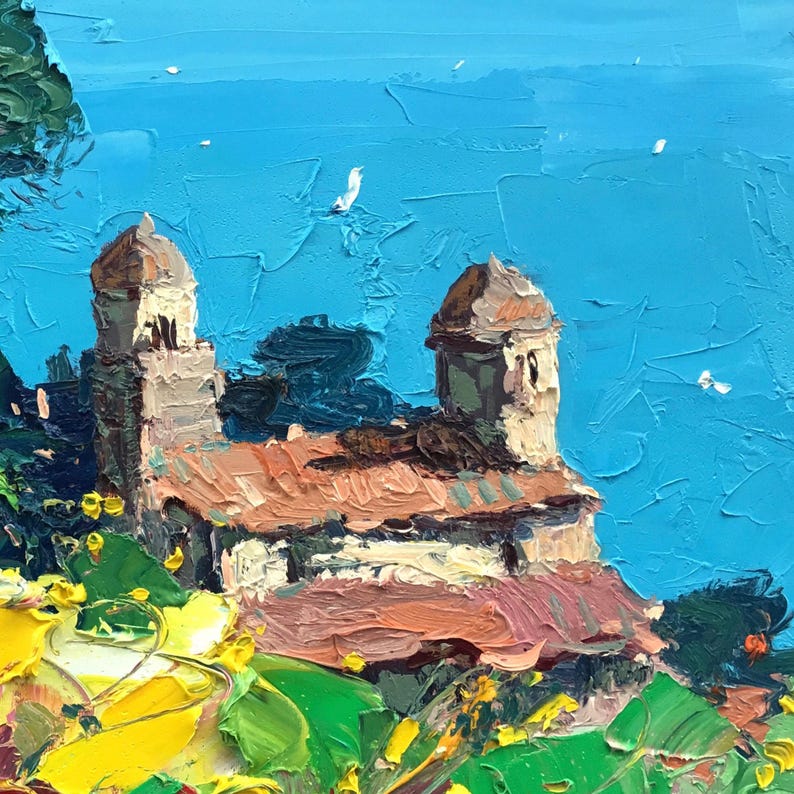Close-up detail of the painting on a neutral background, showing a coastal church and rooftops with thick impasto texture against a bright blue sea and sky.