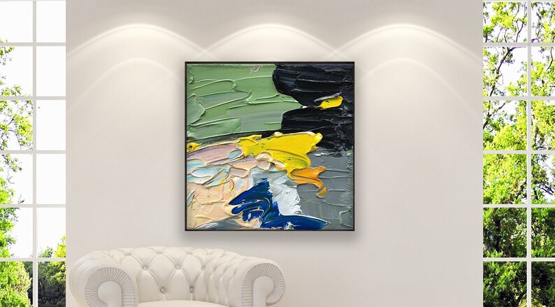 Abstract oil painting on canvas hanging in a modern living room with a white sofa and home decor
