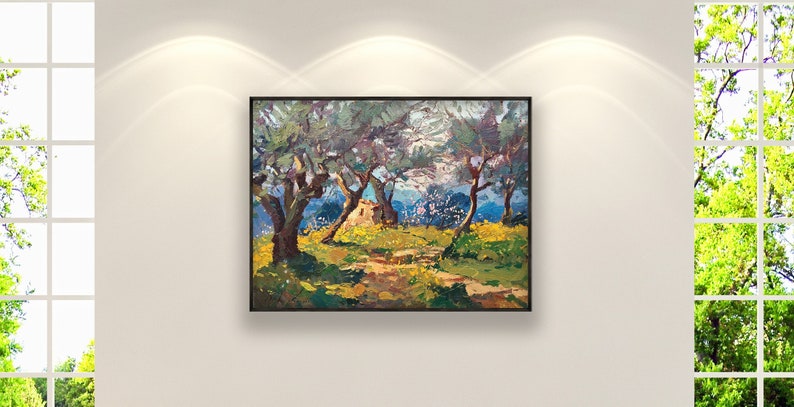 Framed oil painting of Tuscan olive trees with textured impasto brushstrokes, green foliage and sunlit yellow field, displayed in a modern interior.