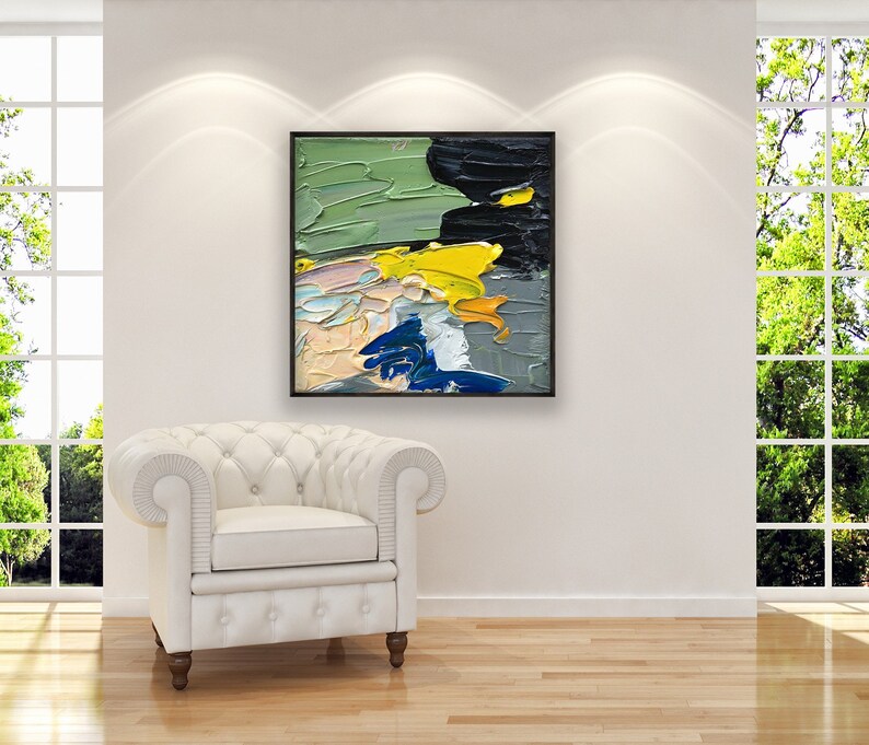 Abstract oil painting on canvas hanging in a modern living room with a white sofa and home decor