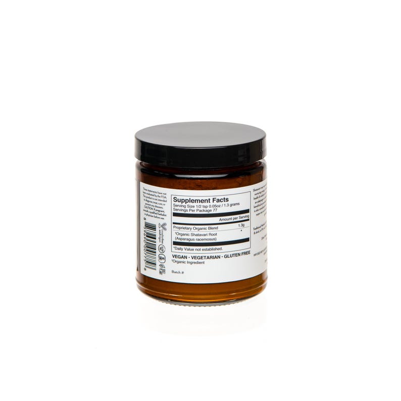 May include: A brown glass jar with a black lid containing a supplement powder. The label reads "Supplement Facts" and lists the ingredients as "Proprietary Organic Blend" and "Organic Shatavari Root". The label also states that the product is vegan, vegetarian, and gluten free.