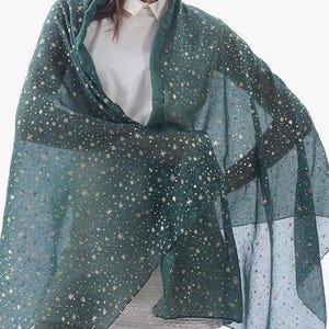 May include: A sheer scarf in green with a gold star pattern.