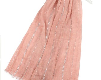 May include: A blush pink scarf with silver metallic stripes. The scarf has a fringed edge.