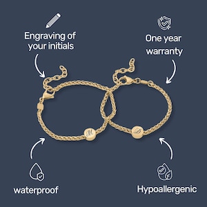 May include: Two gold-colored bracelets with a woven chain design. Each bracelet features a round charm with an engraved initial. The image includes text that says "Engraving of your initials", "One year warranty", "waterproof", and "Hypoallergenic".