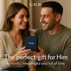 May include: A couple smiles while holding a navy blue gift box with the brand name "GALIS" on it. The text "The perfect gift for Him" and "romantic, meaningful and full of love" is displayed below the box.