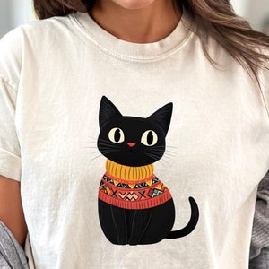 Black Cat Wearing Sweater Shirt, Cute Black Cat Lover Tee, Cozy Cat Mom Gift, Funny Cat Graphic Shirt, Unisex Cat T-Shirt for Women