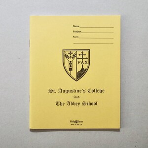 May include: A yellow notebook featuring the text "St. Augustine's College And The Abbey School" and a crest. The notebook has spaces for "Name", "Subject", and "Form". It is marked as made in the UK.