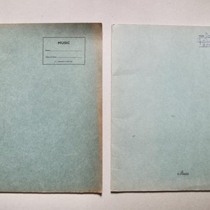 May include: Two blank blue paper notebooks with the word "MUSIC" printed on the front cover of one notebook. The other notebook has handwritten text on the front cover: "Donny Max Springwood High 1970-1974".