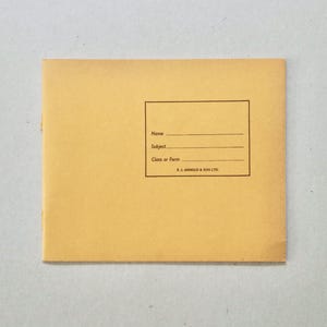 May include: A buff-coloured envelope featuring a rectangular label for name, subject, and class or form. The text "P.J. ARNOLD & SON LTD." is printed at the bottom of the label. The envelope is on a light grey surface.