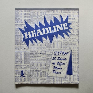 May include: A blue and white notepad with the word "HEADLINE!" in a large, bold font. The notepad has a blue and white striped border and says "EXTRA! 80 Sheets of Office Memo Paper" on the front.