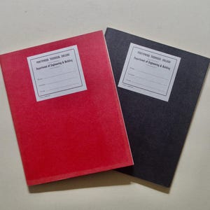 May include: Two notebooks, one red and one black, are shown on a light surface. Each notebook has a white label with the text "Portypool Technical College, Department of Engineering & Building."