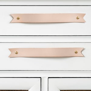 Leather Handles installed on a white dresser.