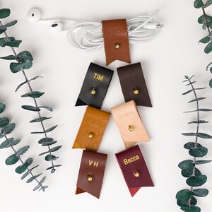 Small Leather Cord Holders displayed on a white background displaying available colors.
