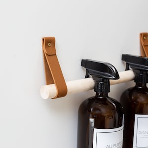 Under the Kitchen Sink Cabinet Door Storage rail for cleaning product organizer spray bottle holder towel rack space saving pantry design