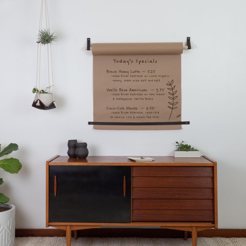 A Kraft Paper Holder installed on the wall above a dresser.