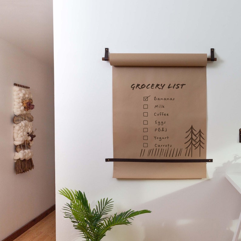 A Kraft Paper Holder installed on the wall next to a desk.