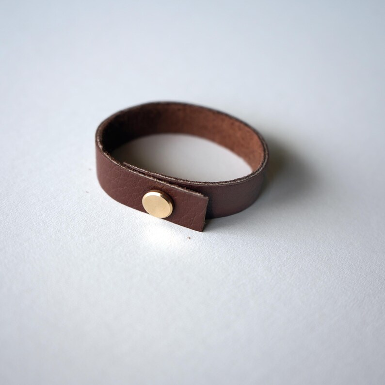 Medium brown Walnut leather loop made from supple full-grain leather with a modern brass screw closure detail handmade by keyaiira