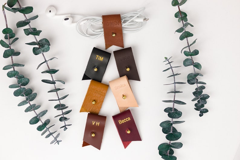 Small Leather Cord Holders displayed on a white background displaying available colors.