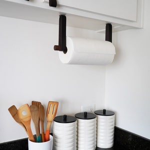 A Paper Towel Holder installed under a cabinet in a kitchen.