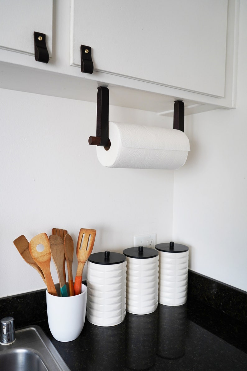 A Paper Towel Holder installed under a cabinet in a kitchen.