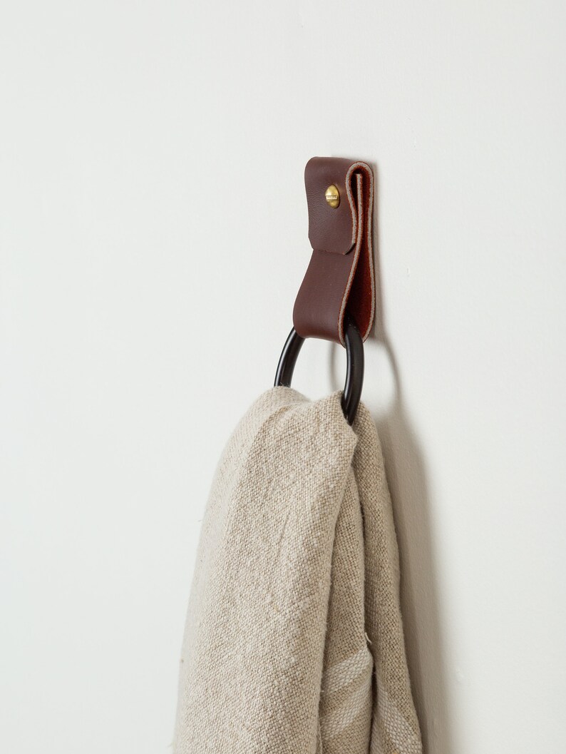 Leather Wall Strap installed on the wall and styled with a kitchen towel looped inside the metal ring.