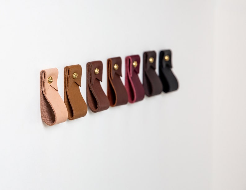 A row of installed wall straps lined up on a wall displaying all available colors.