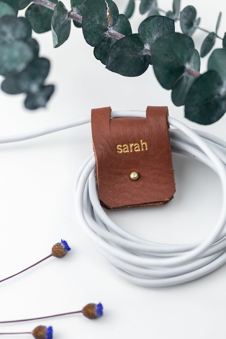 Leather Cable Holder shown wrapping a cable.