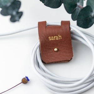 Large Leather Cord Holder displayed on a white background wrapped around a cord.