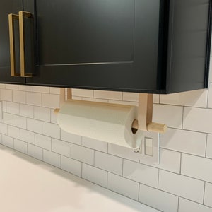 A Paper Towel Holder installed under a cabinet in a kitchen.