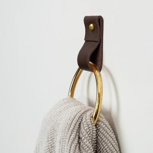 Leather Wall Strap installed and styled with a fluffy bathroom towel looped inside the metal ring.