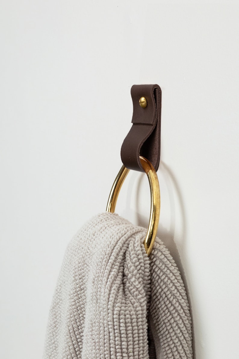 Leather Wall Strap installed and styled with a fluffy bathroom towel looped inside the metal ring.