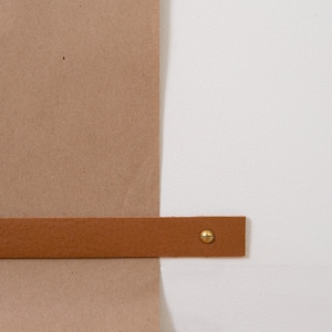 Closeup of the Paper Securing Strap which holds the paper down against the wall.