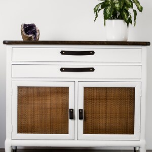 Leather Pulls installed on a white dresser on the bottom doors.