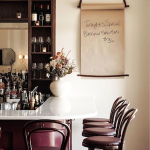 Keyaiira wall mounted kraft paper holder styled as a restaurant menu board, handcrafted with leather straps and solid wood dowels, perfect for cafe menu displays, restaurant specials, event signage, wedding welcome signs, and modern commercial decor.