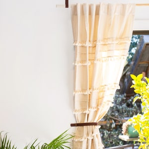Curtains hanging from a wooden dowel and Leather Suspension Straps.