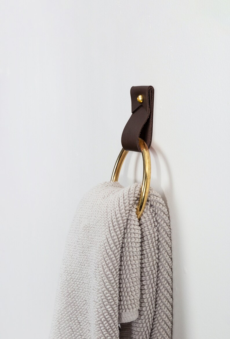 Leather Wall Strap installed and styled with a fluffy bathroom towel looped inside the metal ring.