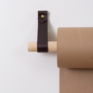 Closeup of the Leather Strap and Dowel which hold the Kraft Paper Roll.