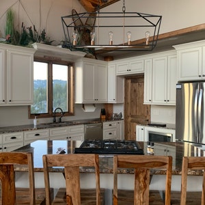 A kitchen dining scene with a Paper Towel Holder installed under a cabinet.