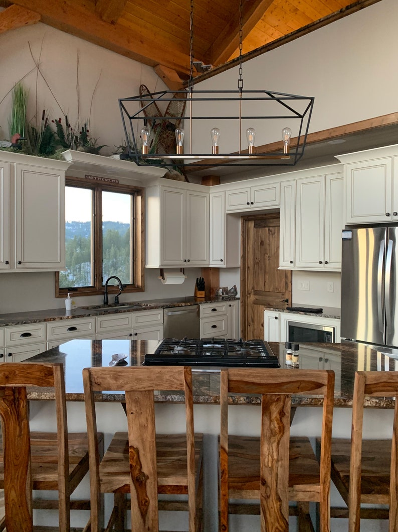 A kitchen dining scene with a Paper Towel Holder installed under a cabinet.